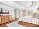 Spacious main bedroom with a flat-screen tv, wood floors, modern decor, and an en suite bathroom with a double vanity at 15124 Hugh Mcauley Rd, Huntersville, NC 28078