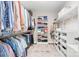 Walk-in closet with a hanging rack, a shelving unit, shoe racks, and folded shirts, pants, and sweaters at 15124 Hugh Mcauley Rd, Huntersville, NC 28078