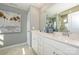 Well-lit bathroom with double vanity, white cabinets, stylish decor, and framed mirror at 15311 Lake Ridge Rd, Charlotte, NC 28278