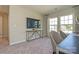 Neutral room featuring gray carpet, a decorative table, and natural light from large windows at 15311 Lake Ridge Rd, Charlotte, NC 28278