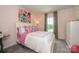 Cozy bedroom with a floral painting, large window, and upholstered headboard at 15311 Lake Ridge Rd, Charlotte, NC 28278