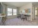 Well-lit room featuring two study spaces with gray carpet, and natural light from large windows at 15311 Lake Ridge Rd, Charlotte, NC 28278