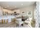 Open-concept dining area with view of kitchen, hardwood floors, and elegant chair set at 15311 Lake Ridge Rd, Charlotte, NC 28278