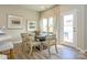 Cozy dining room with elegant chairs, hardwood floors, and views of the outdoor patio at 15311 Lake Ridge Rd, Charlotte, NC 28278
