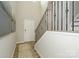 Inviting entryway with hardwood floors, staircase with decorative wrought iron railing, and neutral paint at 15311 Lake Ridge Rd, Charlotte, NC 28278