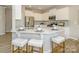 Modern kitchen with white cabinets, stainless steel appliances, quartz countertop, and breakfast bar seating at 15311 Lake Ridge Rd, Charlotte, NC 28278