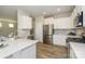 Well-lit kitchen features stainless steel appliances, white cabinets, and a stylish tile backsplash at 15311 Lake Ridge Rd, Charlotte, NC 28278