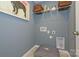 Functional laundry room with overhead shelving, a dog bed, and modern decor at 15311 Lake Ridge Rd, Charlotte, NC 28278