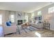 Bright living room features a fireplace, neutral furniture, hardwood floors, and elegant window curtains at 15311 Lake Ridge Rd, Charlotte, NC 28278