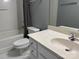 Clean bathroom featuring a bathtub, toilet, vanity, and new laminate floor at 1634 Walnut View Dr, Charlotte, NC 28208