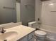 Bright bathroom featuring a vanity with sink, toilet and a shower-tub combo at 1634 Walnut View Dr, Charlotte, NC 28208