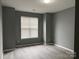 Well-lit bedroom with new laminate floors, neutral paint, and large window at 1634 Walnut View Dr, Charlotte, NC 28208