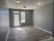 Bright, open living room featuring gray walls and modern laminate flooring at 1634 Walnut View Dr, Charlotte, NC 28208