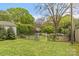 Beautiful backyard featuring manicured lawn, decorative iron gate, and lush greenery for a private outdoor retreat at 1644 Morningside Dr, Charlotte, NC 28205
