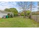 Backyard featuring grass, a fence, an out-building, and mature shade trees at 1644 Morningside Dr, Charlotte, NC 28205