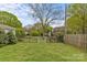 Backyard featuring well-maintained grass, mature trees, and lush shrubbery at 1644 Morningside Dr, Charlotte, NC 28205