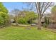 Expansive backyard with lush lawn, mature trees, and defined flower beds offering a serene outdoor space at 1644 Morningside Dr, Charlotte, NC 28205