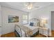 Cozy bedroom with hardwood floors, a ceiling fan, and a decorative painting at 1644 Morningside Dr, Charlotte, NC 28205