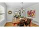 Bright dining room features hardwood floors, modern lighting, and an open view into the cozy living area at 1644 Morningside Dr, Charlotte, NC 28205