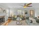 Light-filled living room features hardwood floors, a fireplace, comfortable sofas, and lots of natural light at 1644 Morningside Dr, Charlotte, NC 28205