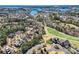 Aerial view of homes and community near a golf course and lake, showcasing the landscape and location at 16744 Ashton Oaks Dr, Charlotte, NC 28278