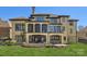 Spacious backyard featuring a patio, stone fire pit, and lush green lawn at 16744 Ashton Oaks Dr, Charlotte, NC 28278