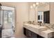 Elegant bathroom featuring double sinks, modern fixtures, and tile backsplash at 16744 Ashton Oaks Dr, Charlotte, NC 28278