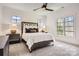 Comfortable bedroom featuring a large window, decorative headboard, and well-coordinated furnishings at 16744 Ashton Oaks Dr, Charlotte, NC 28278
