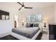 Modern bedroom with large windows, plush carpet, and stylish gray bedding for ultimate relaxation at 16744 Ashton Oaks Dr, Charlotte, NC 28278