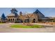 Community clubhouse with stone facade, circular drive, and mature trees at 16744 Ashton Oaks Dr, Charlotte, NC 28278
