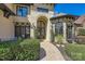 Close up of the front entrance features an arched doorway and a stone accent wall at 16744 Ashton Oaks Dr, Charlotte, NC 28278