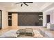 Modern living room features a decorative wall, built-in shelves, and stylish neutral-toned furnishings at 16744 Ashton Oaks Dr, Charlotte, NC 28278
