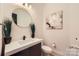 Modern powder room featuring a round mirror and clean design at 16744 Ashton Oaks Dr, Charlotte, NC 28278