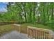 Wooden back deck overlooks a beautiful yard and towering trees at 1837 Academy St, Charlotte, NC 28205
