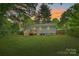Well-maintained backyard with a wooden deck, fenced perimeter, and lush green lawn at 1837 Academy St, Charlotte, NC 28205