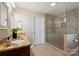 Updated bathroom featuring a glass-enclosed shower and granite vanity; bright and airy at 1837 Academy St, Charlotte, NC 28205
