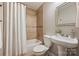 Bathroom with tiled shower/tub, pedestal sink, and decorative mirror create a functional space at 1837 Academy St, Charlotte, NC 28205