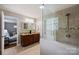 Updated bathroom featuring a glass-enclosed shower, granite vanity, and views into an adjacent bedroom at 1837 Academy St, Charlotte, NC 28205