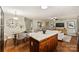 Open-concept kitchen and dining area with a granite island, hardwood floors and stainless steel appliances at 1837 Academy St, Charlotte, NC 28205