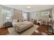 Serene bedroom retreat with hardwood floors, neutral tones, and abundant natural light from multiple windows at 1837 Academy St, Charlotte, NC 28205