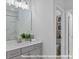 Bright bathroom features a gray vanity with a white countertop, a framed mirror, and modern fixtures at 19728-B School St, Cornelius, NC 28031