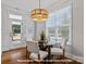Bright breakfast nook featuring a modern chandelier, wood floors and lots of light at 19728-B School St, Cornelius, NC 28031