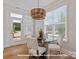 Bright breakfast nook featuring a modern chandelier, wood floors and lots of light at 19728-B School St, Cornelius, NC 28031