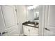Bathroom vanity features a gray countertop, white cabinets, and an attractive light fixture at 19732-A School St, Cornelius, NC 28031