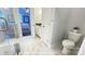 A modern bathroom featuring marble flooring, white cabinets, and a toilet with a plant on the tank at 19732-A School St, Cornelius, NC 28031