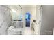 A luxurious bathroom with a glass-enclosed shower, marble tile, and a view of the bedroom at 19732-A School St, Cornelius, NC 28031