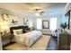 Well-lit bedroom with neutral tones, stylish furnishings, and a ceiling fan at 19732-A School St, Cornelius, NC 28031