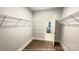 Spacious walk-in closet with custom shelving and wood-look floors for maximum storage at 19732-A School St, Cornelius, NC 28031