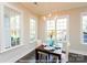 Bright dining room with large windows, a chandelier, and a table set for a meal at 19732-A School St, Cornelius, NC 28031