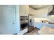 Modern kitchen with stainless steel appliances, white cabinets, and a herringbone backsplash at 19732-A School St, Cornelius, NC 28031